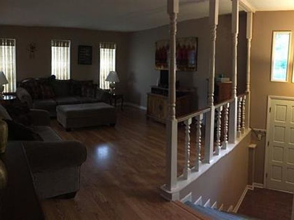 This split level floor plan features railing and recently installed laminate flooring