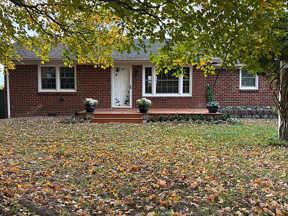 Front of house sets among large, beautiful trees