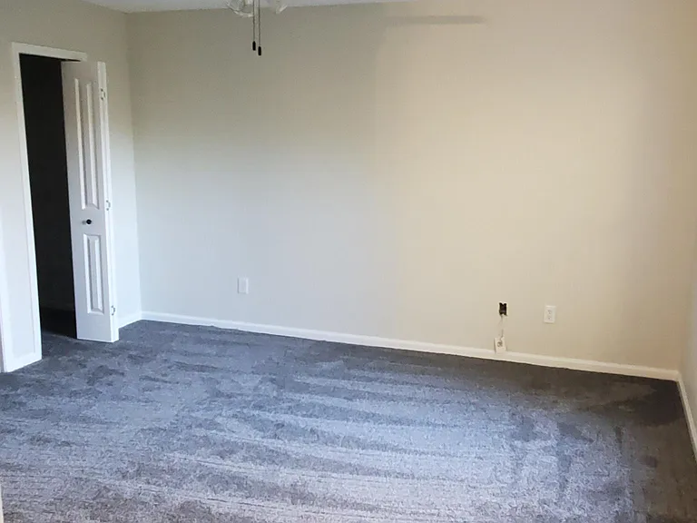 Master Bedroom featuring wall to wall carpeting,two ceiling fans, private bathroom and walk in closet.