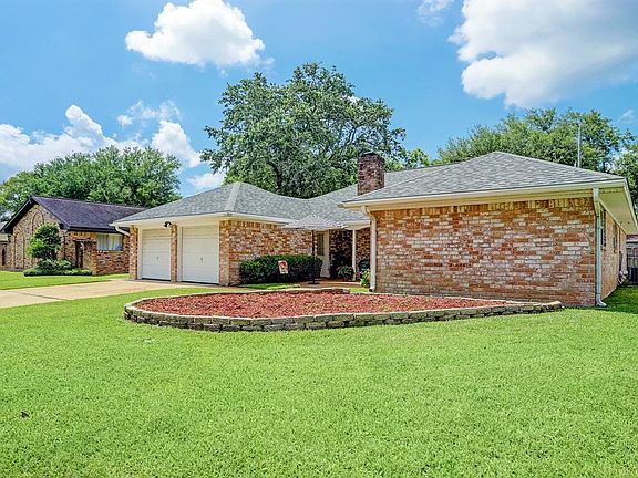 Easy to maintain front yard has lush lawn and again, a the cleared and ready bed for xeriscaping, planting native drought tolerant species, a vegetable or a floral cutting garden.