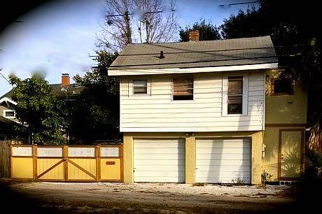 2620 Rear- Apartment upstairs, Fenced patio on left, Storage on right.