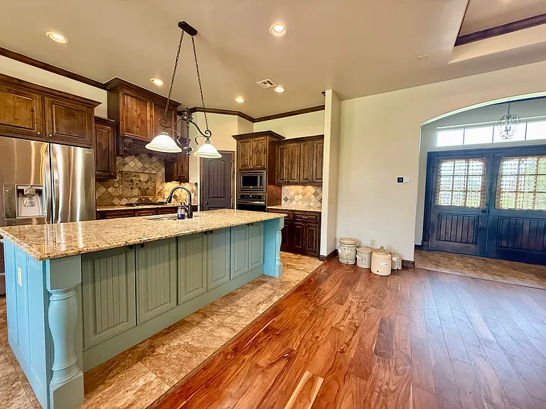 Acacia floors have gorgeous marbling that adorns the living room and a couple of bedrooms. Lots of natural light as you can see reflecting off the floors.