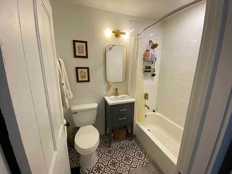 Bathroom off the kitchen shower/tub combo