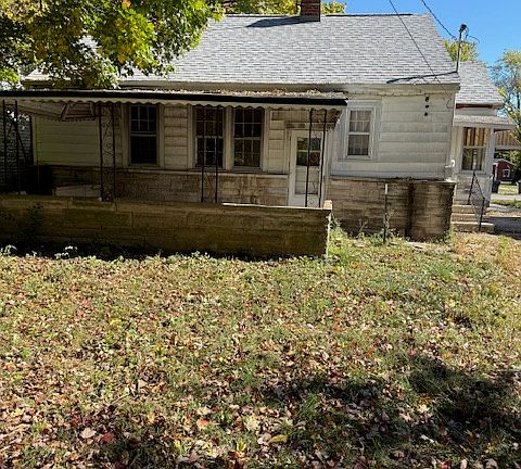 back of yard with view of covered patio