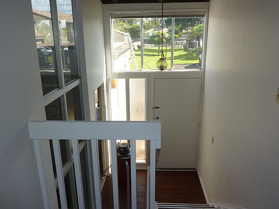 Top of upstairs looking at entry door, to the left of entry door garage entry from inside unit