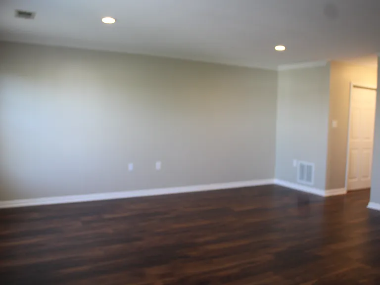Primary bedroom view to hall to closets and bath