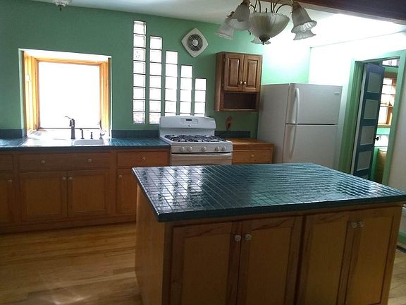 Kitchen with refrigerator and oven/range.