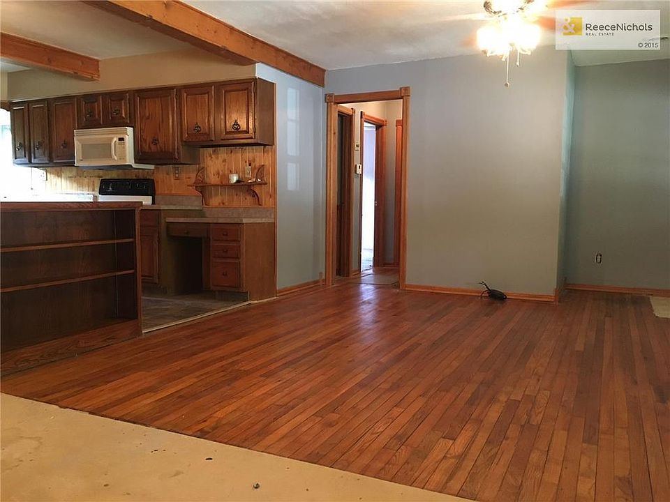 Living room has hardwood floors and is open to kitchen.