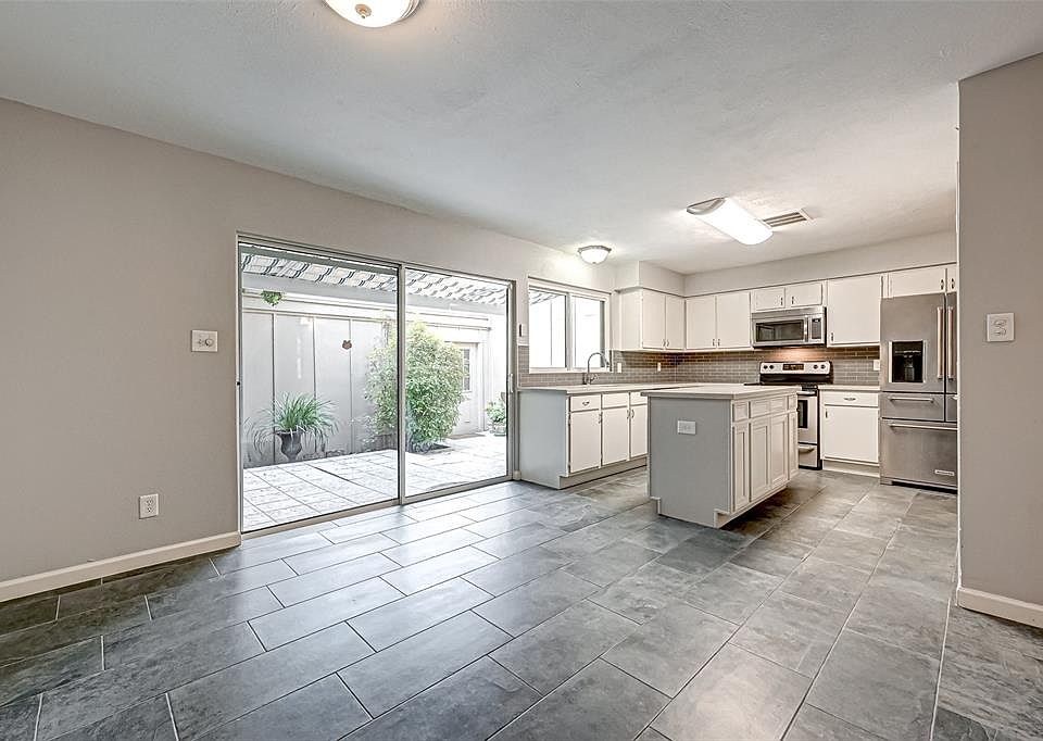 Large open kitchen with attached den, dining room or office. Frig in the photo is not the one that conveys with the property. See additional photos