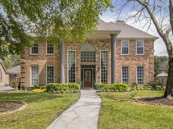 The facade is Colonial Style with tall windows that allow plenty of light into the homes. The Pillars were originally white, and the owners have painted them gray. The landscaping has also been refreshed, and front door refinished.