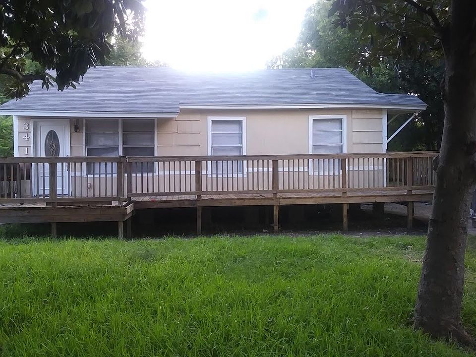 Front of the house, with wrap around porch. The dumpster is