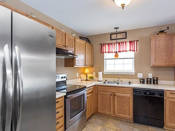 Kitchen offers updated appliances, cabinet hardware, lighting and pretty ceramic tiled floor.