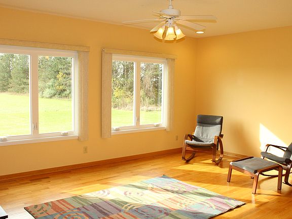 The main living room has large windows to look out onto the 10 acres.
