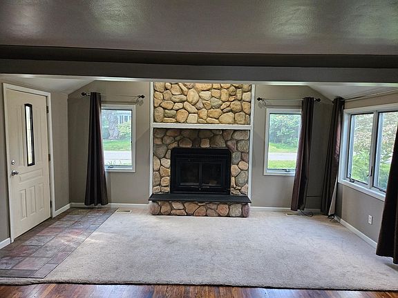 Living room with word burning fireplace