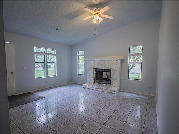 Living Room with fireplace and ceiling fan.