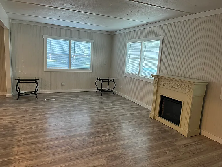 Large open living area, new flooring and freshly painted.