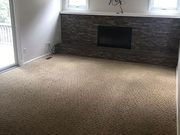 Family room with gas fireplace & flat screen tv hook-up. Slider exits to screened-in patio.