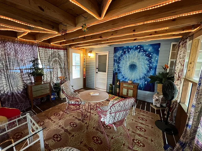 Huge private, screened-in patio with rope lighting and tapestry curtains. Lovely table and chairs. Carpeted. Boho cushions for extra seating. Boho dressers (2) for extra storage. Door entry to apartment. Exit to stairs/carport (left of entry door)
