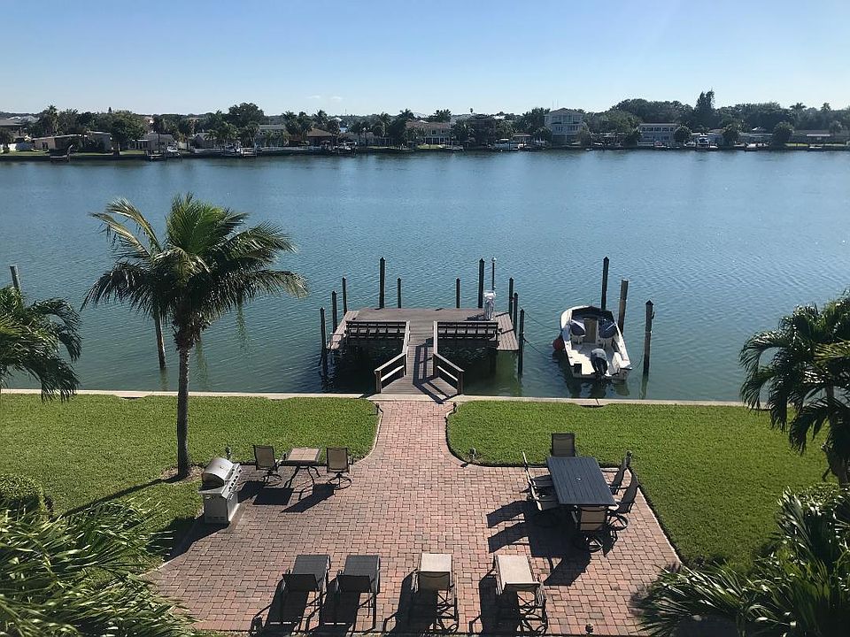 Waterfront courtyard with grilling station for resident use along with dock and boat slips. In the evening the courtyard and walkways are lighted to create a tropical paradise