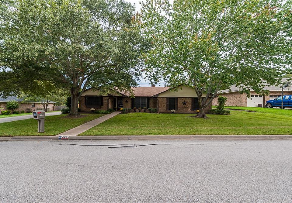 Stunning curb appeal with plenty of shade trees