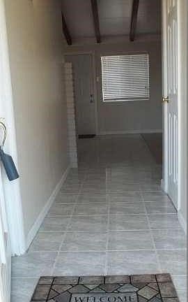 Nice tiled entry with 1/2 guest bath on the left and hall leading directly into living & dining room