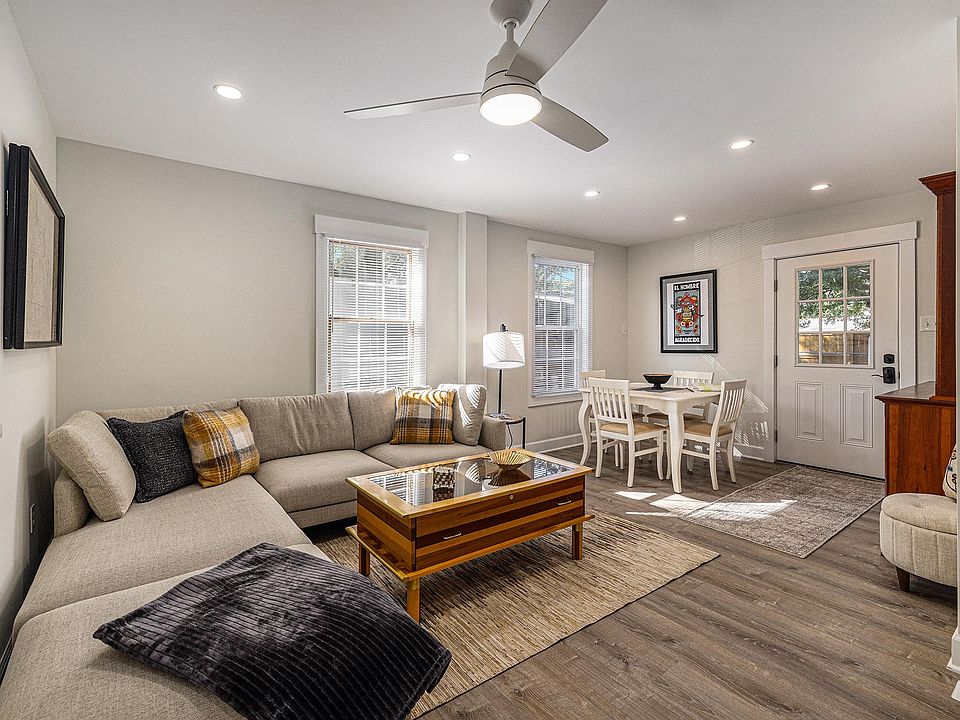 Living area with sectional sofa, Smart TV, and dining table with seating for 4
