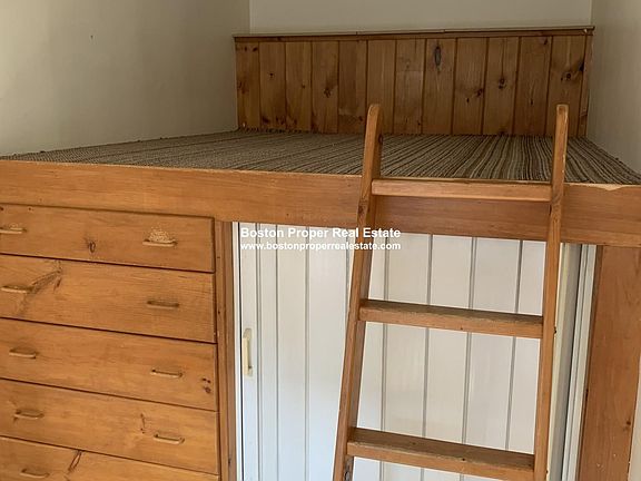 Built-in lofted bedframe with storage comes with the apartment.