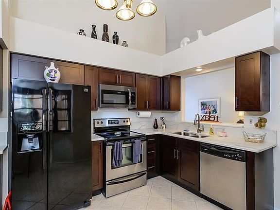 Kitchen Features Espresso Shaker Style Cabinetry with Elegant Quartz Counters & Back splashes!