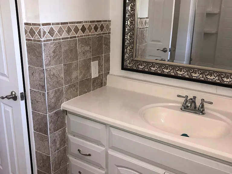 Bathroom with huge mirror and large walk-in closet