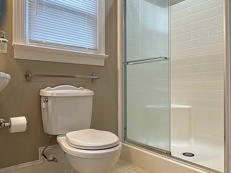 Private full bath with a walk-in (step-in) glass shower, modern and easy to clean.
