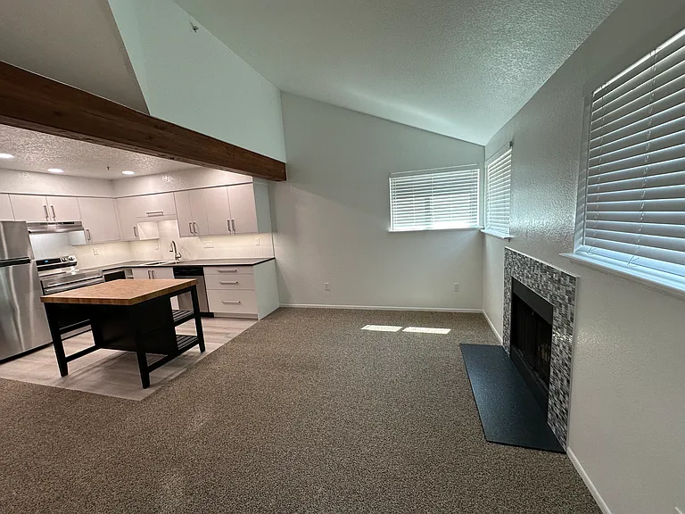New energy-efficient windows bring lots light. Wood-burning chimney with new tile surround and hearth. Wood beam add character.