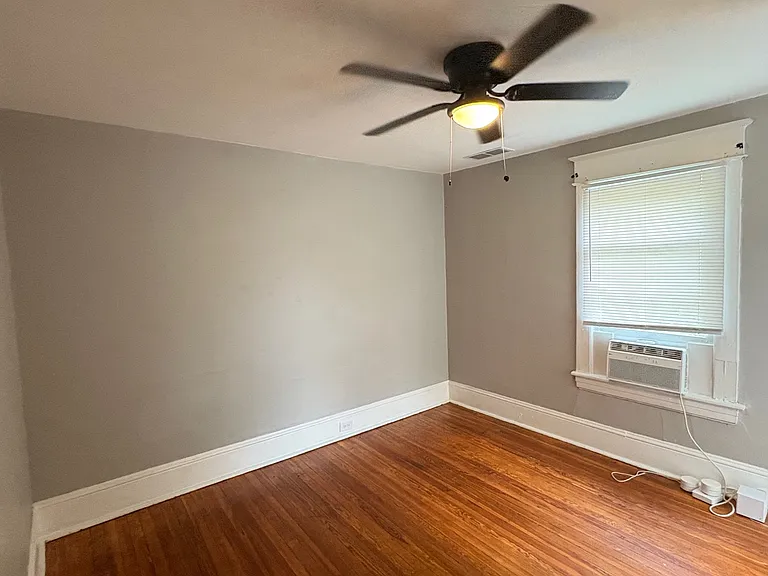 Second Bedroom w/ Designer Ceiling Fan and Newly Refinished Hardwood Floors.