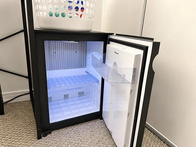Convenient in-room mini fridge offers dedicated space for drinks and grab-and-go essentials, helping keep your room organized