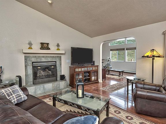Beautiful wood laminate flooring continues into the living and is paired to a ga