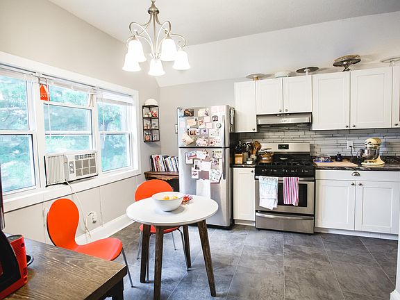 Set up large kitchen with eat-in dining or a coffee station and island. Windows overlook the back yard and trees.
