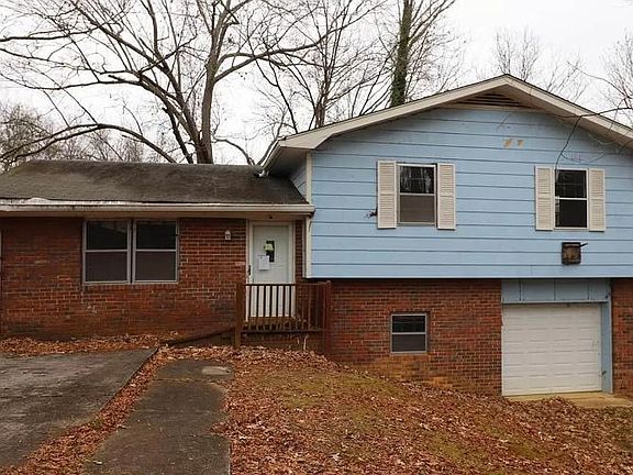 Front of house showcasing two separate drives for top and basement tenants and private entrance for top tenant.
