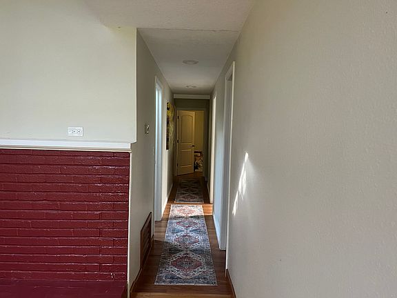 Hallway leading to two additional baths, laundry room and 3-4 additional bedrooms..
