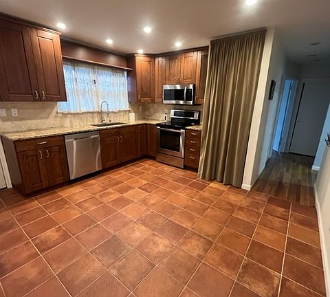 Updated Eat in Kitchen with Granite Countertops and Stainless Steel Appliances.