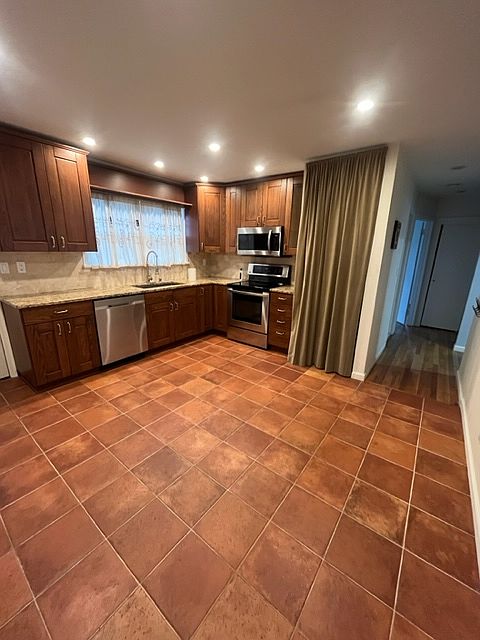 Updated Eat in Kitchen with Granite Countertops and Stainless Steel Appliances.