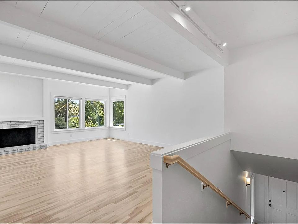Stairs from front door open to very spacious living area with refinished hardwood floors.