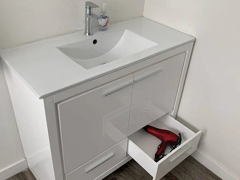 Spacious bathroom with lots of sink counter space and storage for your toiletries. Hair dryer provided.
