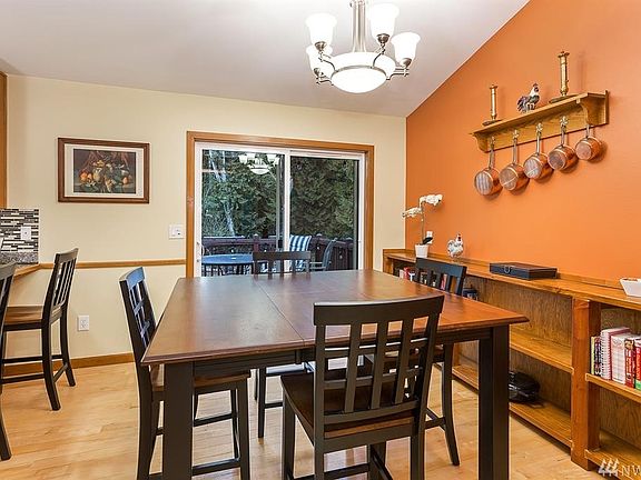 Dining Space with Built-Ins and Deck to Enjoy Summer BBQs and Take in Your Property