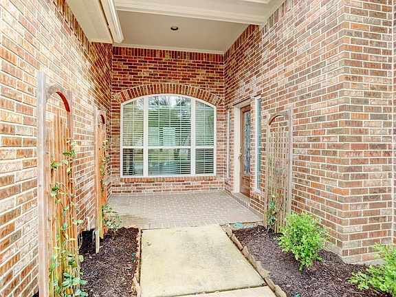 Front entrance with a brick paver porch.