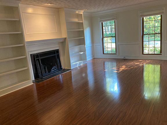 Spacious, inviting room with views of trees.