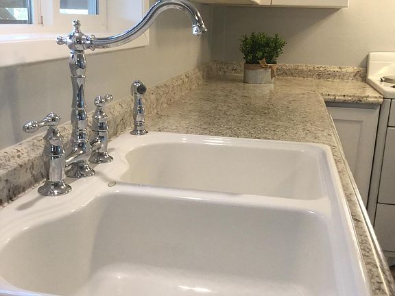 Additional view of cast iron sink and retro faucet.