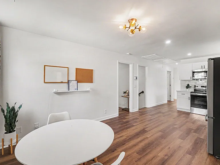 Open-concept kitchen and dining area with ample cabinetry, full-size appliances, and easy-care flooring for daily living.
