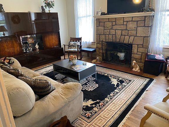 Living room with fireplace and smart TV.