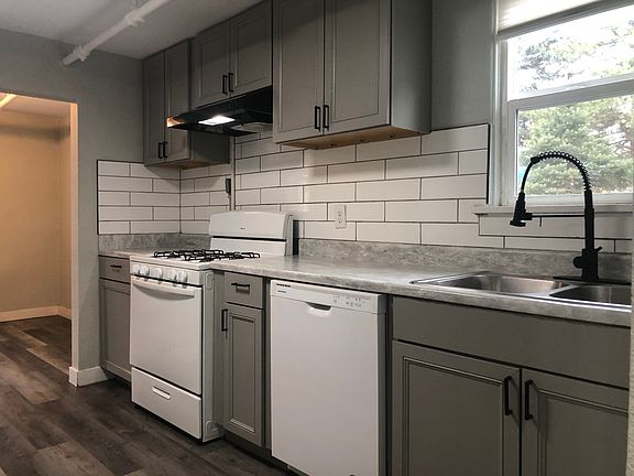 Galley kitchen with gas stove and high neck faucet