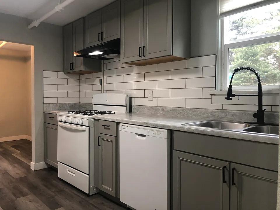 Galley kitchen with gas stove and high neck faucet