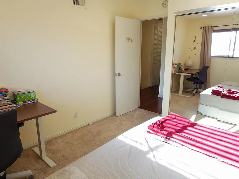 Bedroom with carpets before which have now been replaced with wooden flooring